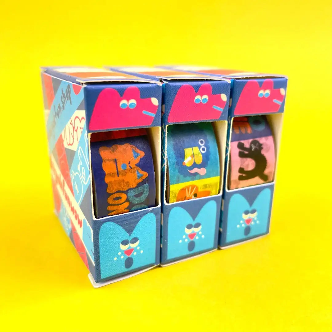 YUK-FUN-Bad-Washi-Tape-15mmx10m-Produktansicht-Tapes-in-Verpackung-auf-gelben-Untergrund