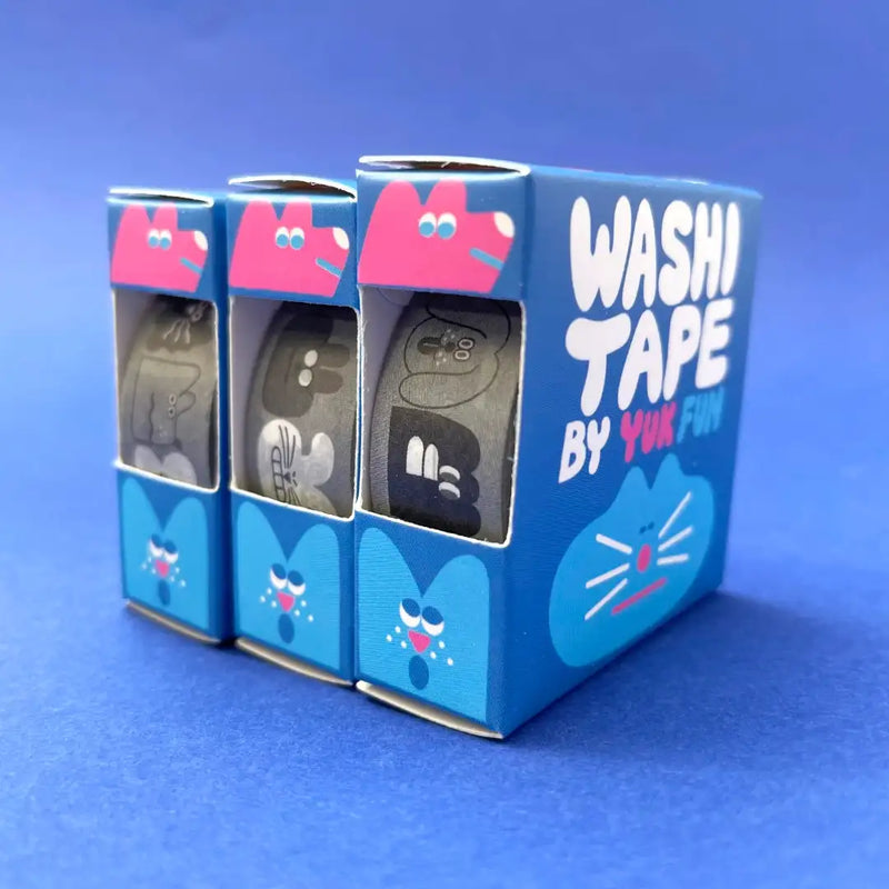 YUK-FUN-Gesichter-schwarz-weiss-Washi-Tape-15mmx10m-Produktansicht-Tapes-in-Verpackung-auf-blauen-Untergrund